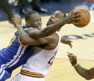 The Cleveland Cavaliers' LeBron James, middle, gets tangled with the Golden State Warriors' Draymond Green, left, during the fourth quarter in Game 4 of the NBA Finals at Quicken Loans Arena in Cleveland on Friday, June 10, 2016. The Warriors won, 108-97, for a 3-1 series lead. (Phil Masturzo/Akron Beacon Journal/TNS)