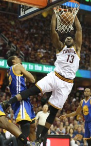 The Cleveland Cavaliers' Tristan Thompson (13) dunks over the Golden State Warriors' James Michael McAdoo during the first quarter in Game 4 of the NBA Finals at Quicken Loans Arena in Cleveland on Friday, June 10, 2016. (Phil Masturzo/Akron Beacon Journal/TNS)